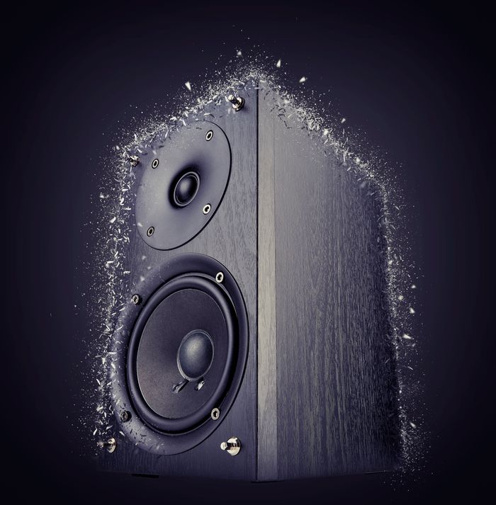 A large speaker shattering around the edges with the force of its own sound.
